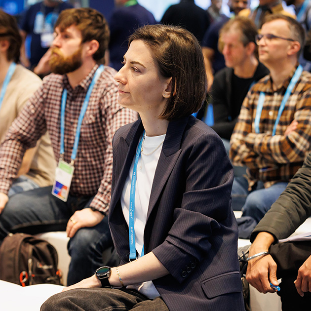 Woman sitting listening to a speaker at Cisco Live Amsterdam